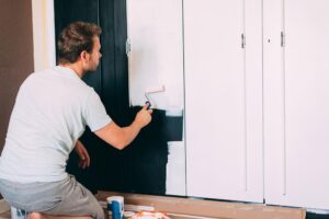 Man painting a wardrobe