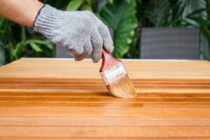 Brush in hand and painting on the wooden table