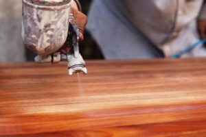 The painter is painting the wooden floor